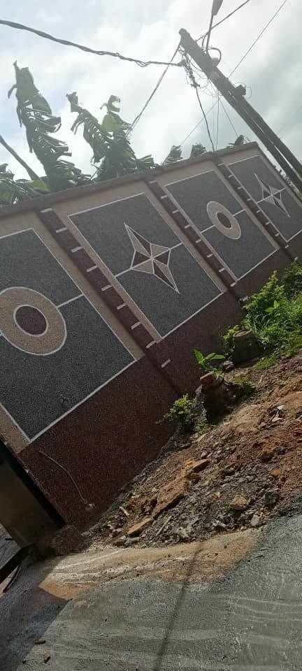 Villa compound gate and perimeter wall with matching granite finish in Cameroon
